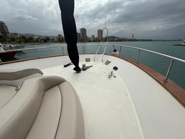  Yacht Photos Pics Apreamare 65 MAESTRO 2011 yacht deck with city skyline and cloudy sky.