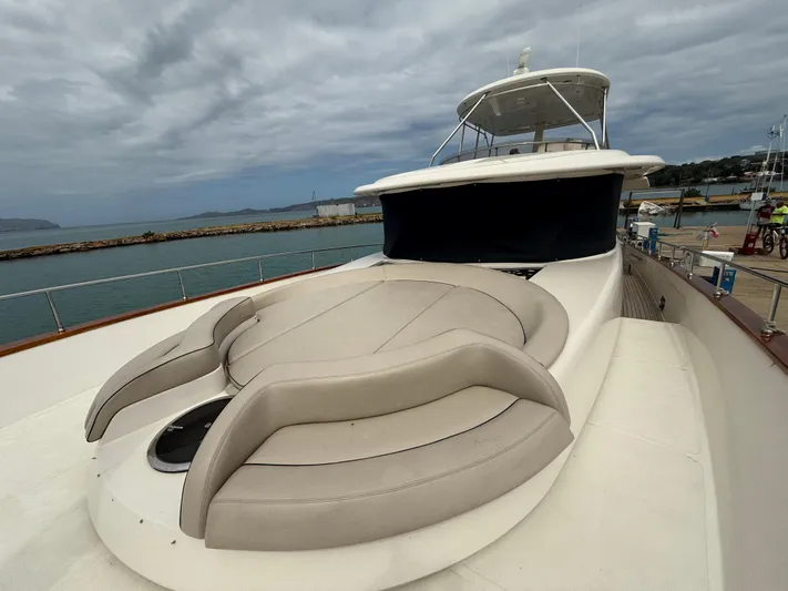  Yacht Photos Pics 2011 Apreamare 65 MAESTRO yacht with spacious deck and seating, docked by the sea.