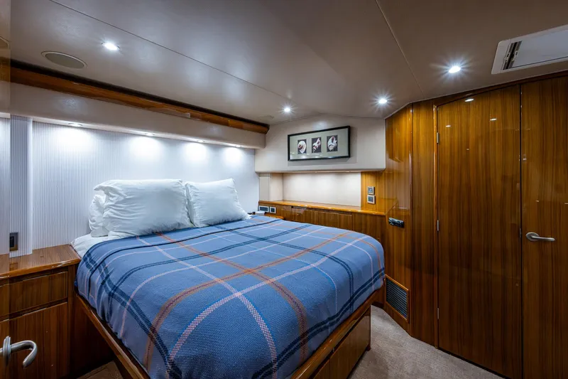 Carolina Style Yacht Photos Pics Luxurious bedroom interior of 2012 Viking 60 Enclosed Bridge yacht with blue plaid bedding.
