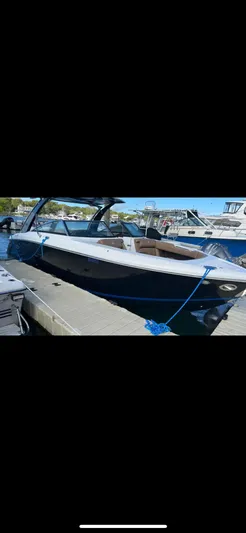  Yacht Photos Pics 2020 Cobalt 30SC Outboard boat docked, featuring sleek design and modern amenities.