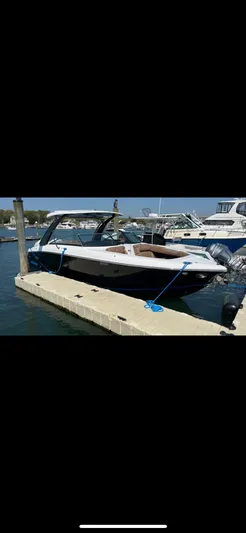  Yacht Photos Pics 2020 Cobalt 30SC Outboard boat docked at marina, sunny day.
