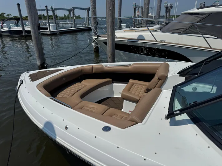  Yacht Photos Pics 2020 Cobalt 30SC Outboard boat with tan seating at a marina dock.
