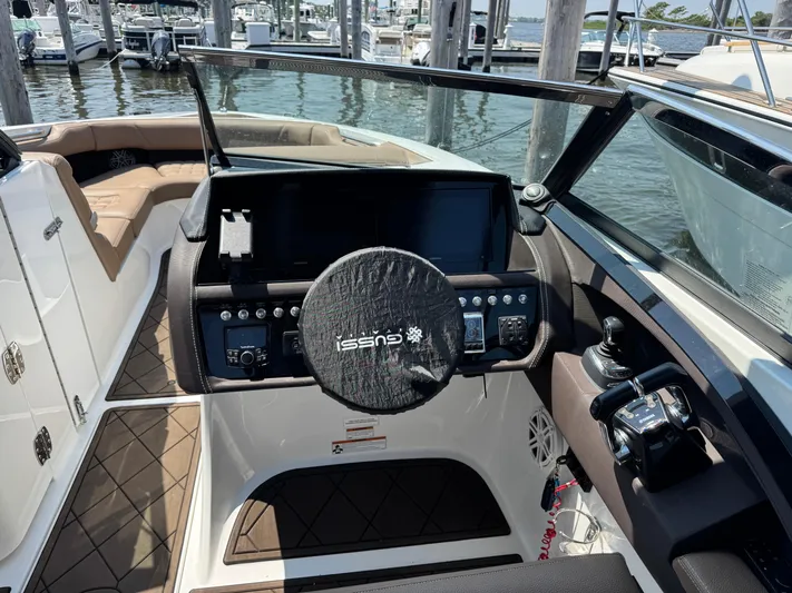  Yacht Photos Pics 2020 Cobalt 30SC Outboard boat helm with steering wheel and control panel at marina.
