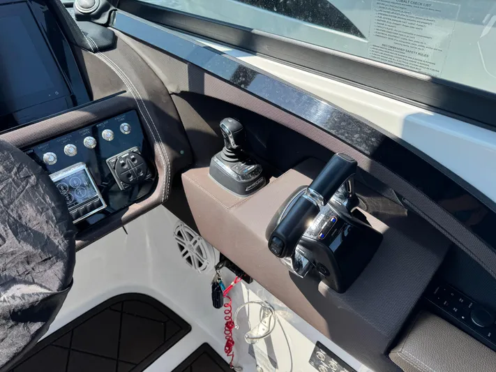  Yacht Photos Pics Control panel of a 2020 Cobalt 30SC Outboard boat with throttle and joystick.