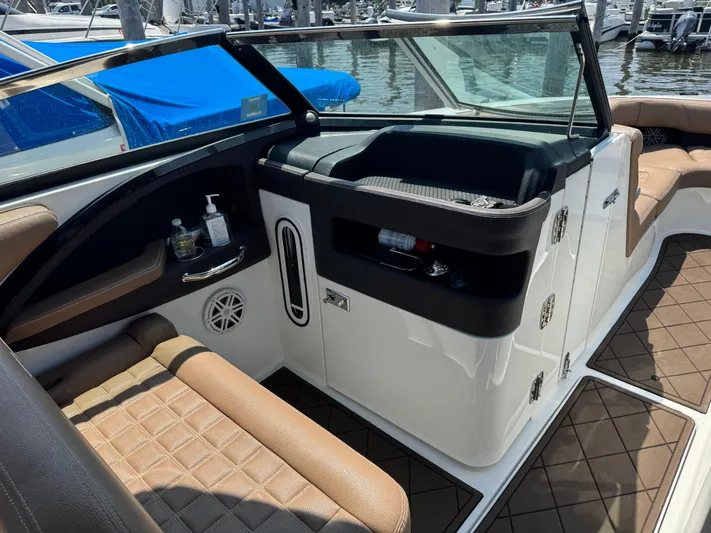  Yacht Photos Pics Interior of a 2020 Cobalt 30SC Outboard boat with brown seating and storage compartments.