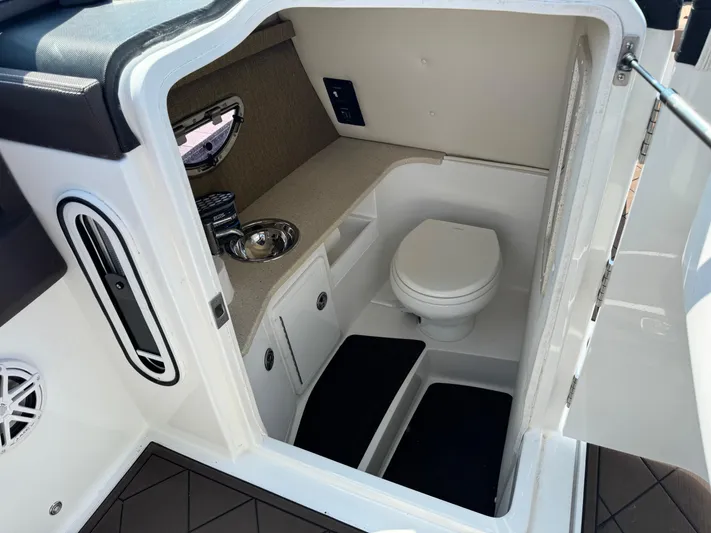  Yacht Photos Pics 2020 Cobalt 30SC Outboard boat interior with compact bathroom and sink.