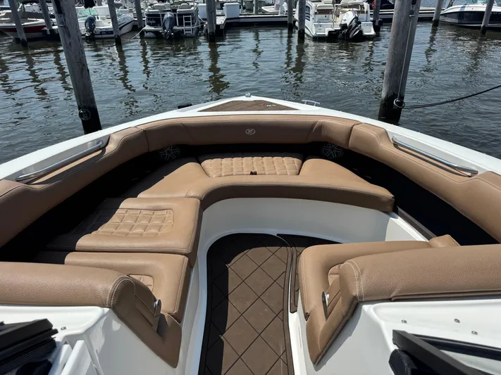  Yacht Photos Pics 2020 Cobalt 30SC Outboard boat with tan leather seating in a marina.