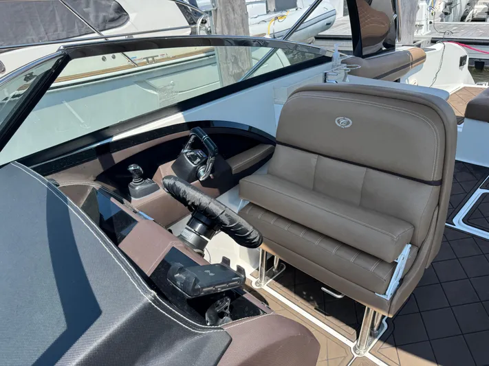  Yacht Photos Pics 2020 Cobalt 30SC Outboard boat interior with steering wheel and brown seating.