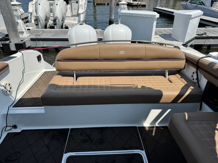  Yacht Photos Pics 2020 Cobalt 30SC Outboard boat interior with tan seating at a marina.