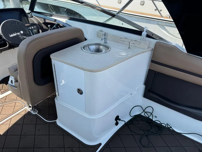  Yacht Photos Pics 2020 Cobalt 30SC Outboard interior with sink and seating area.