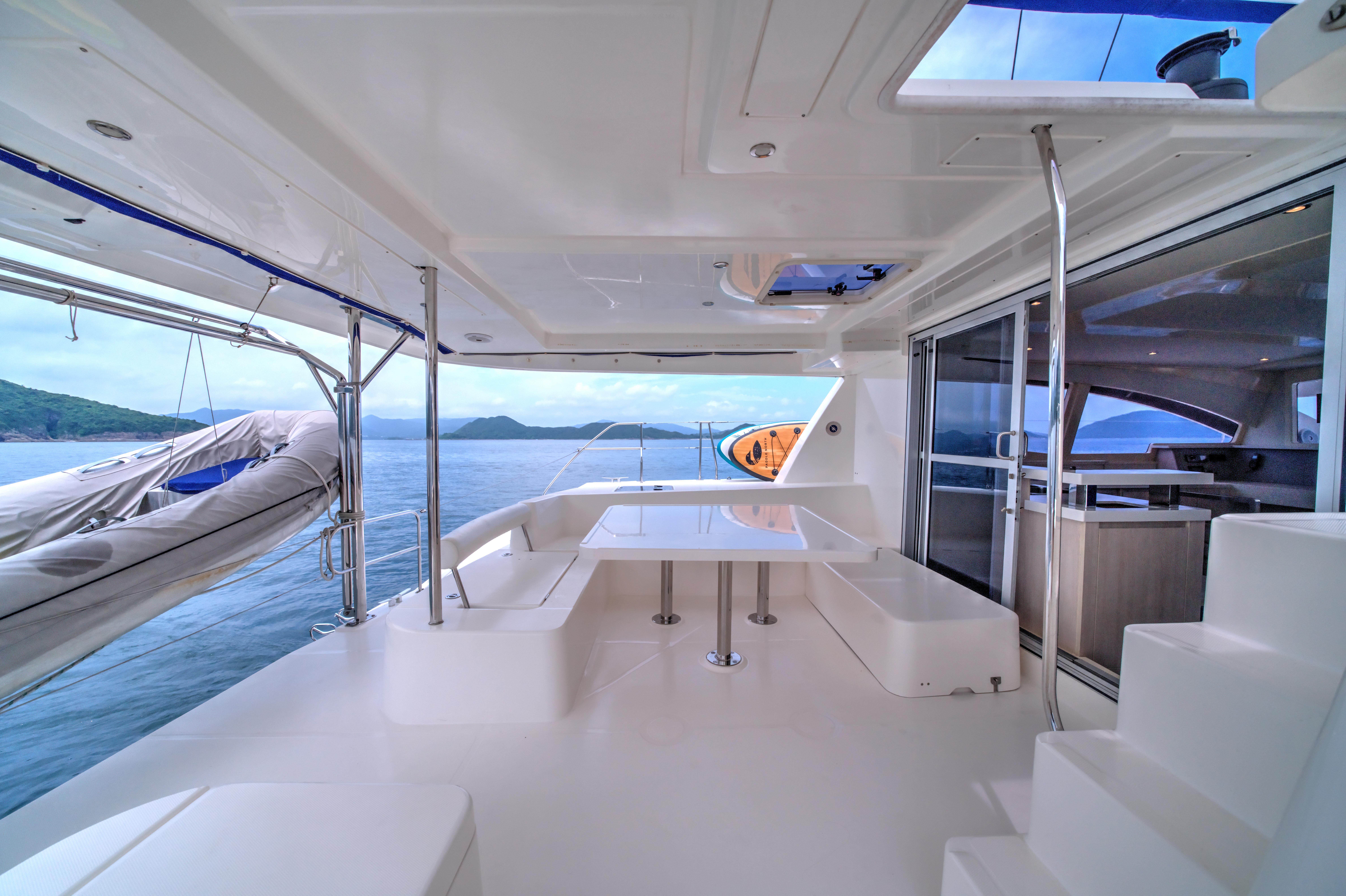 Luxurious Leopard 48 yacht interior, 2015 model, featuring spacious seating and ocean view.