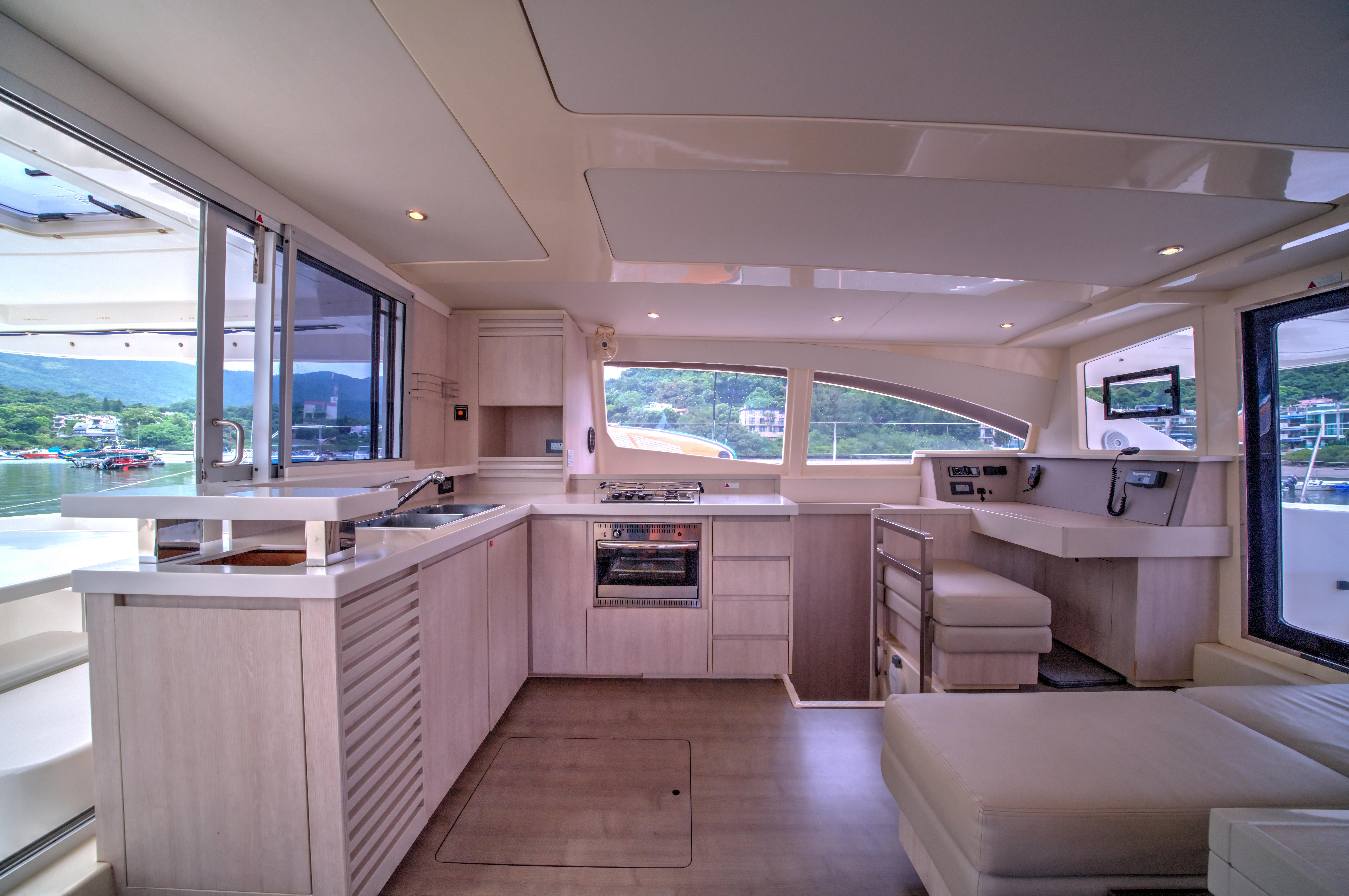 Luxurious interior of a 2015 Leopard 48 yacht with modern kitchen and seating area.