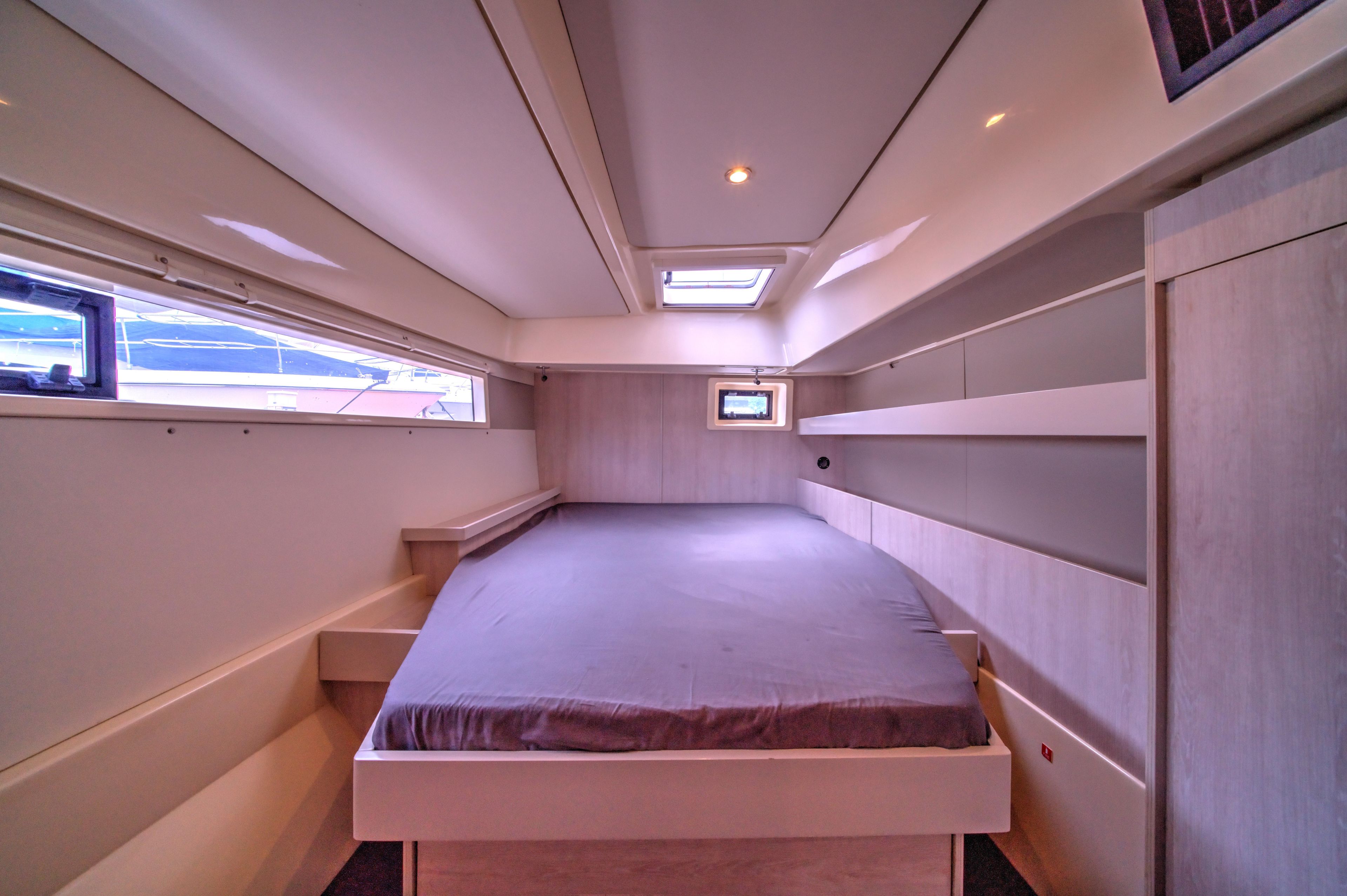 Luxurious cabin interior of 2015 Leopard 48 yacht with modern design and ample natural light.