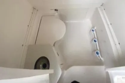  Yacht Photos Pics 2022 Robalo R302 Center Console boat interior with compact restroom facilities.