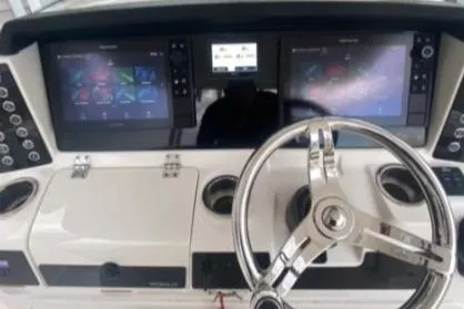 Yacht Photos Pics 2022 Robalo R302 Center Console dashboard with dual screens and steering wheel.