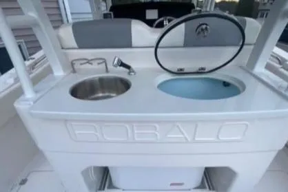  Yacht Photos Pics 2022 Robalo R302 Center Console boat with sink and storage area.