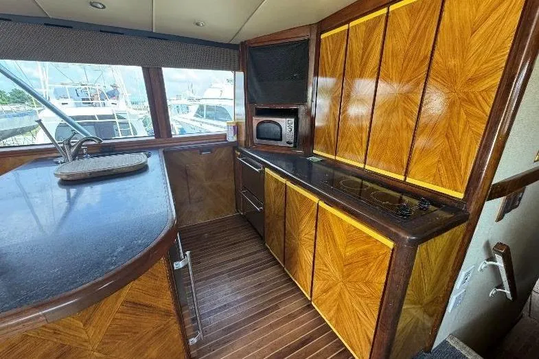  Yacht Photos Pics Luxurious wooden interior of a 1994 Bertram 60 Convertible yacht kitchen.