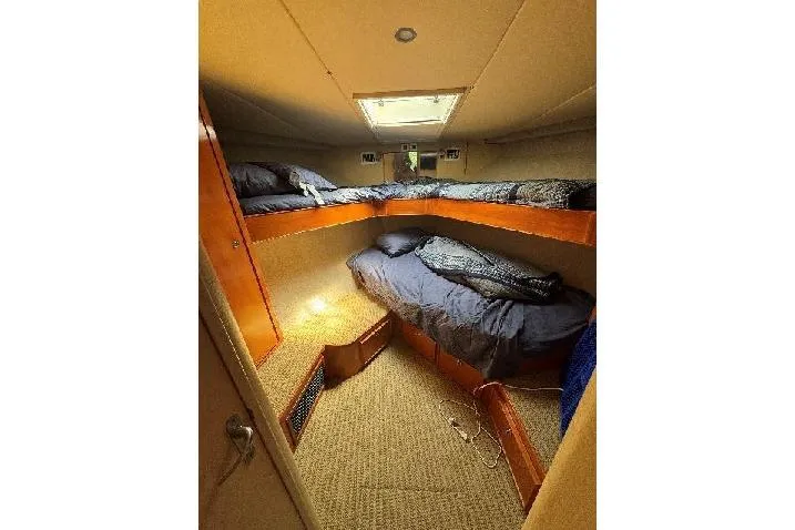  Yacht Photos Pics Cozy cabin interior of 1994 Bertram 60 Convertible yacht with bunk beds.