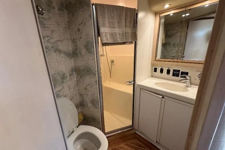  Yacht Photos Pics Bathroom interior of 1994 Bertram 60 Convertible yacht, featuring shower, toilet, and sink.