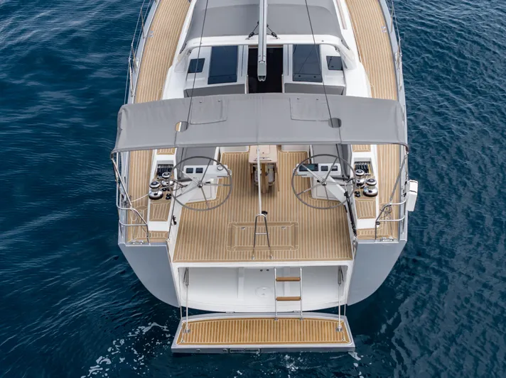  Yacht Photos Pics 2025 Grand Soleil 52 LC yacht, aerial view of deck and helm, sailing on blue water.