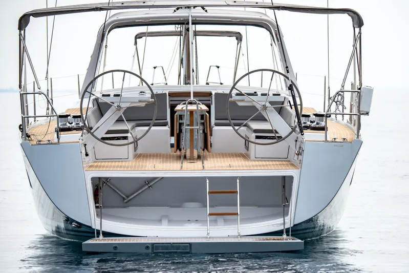  Yacht Photos Pics 2025 Grand Soleil 52 LC yacht, rear view with dual steering wheels and open deck.