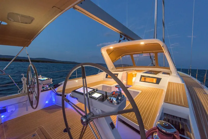  Yacht Photos Pics Luxurious 2025 Grand Soleil 52 LC yacht cockpit at sunset, featuring modern navigation equipment.