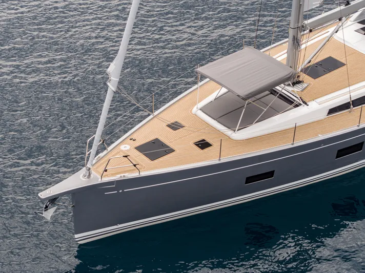  Yacht Photos Pics 2025 Grand Soleil 52 LC yacht with sleek design and wooden deck on calm water.