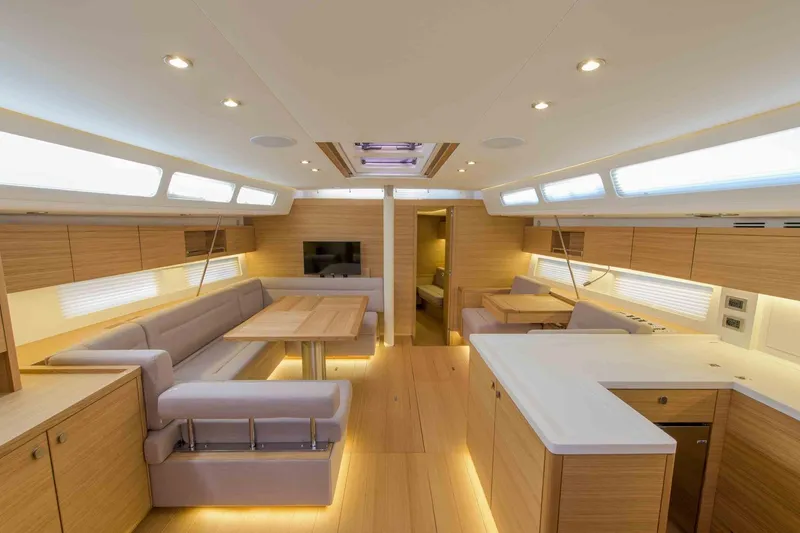  Yacht Photos Pics Luxurious interior of 2025 Grand Soleil 52 LC yacht with modern wood finish and spacious seating.