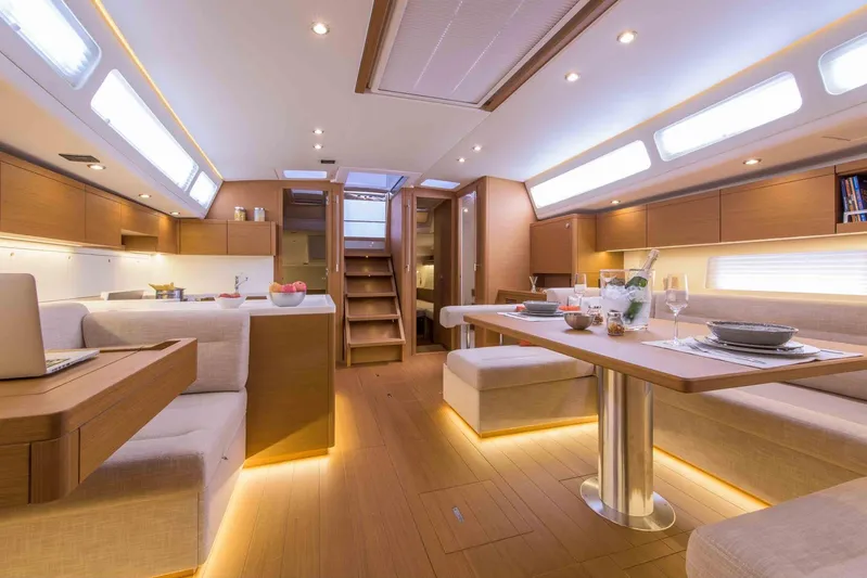  Yacht Photos Pics Luxurious interior of 2025 Grand Soleil 52 LC yacht with modern dining area and ambient lighting.