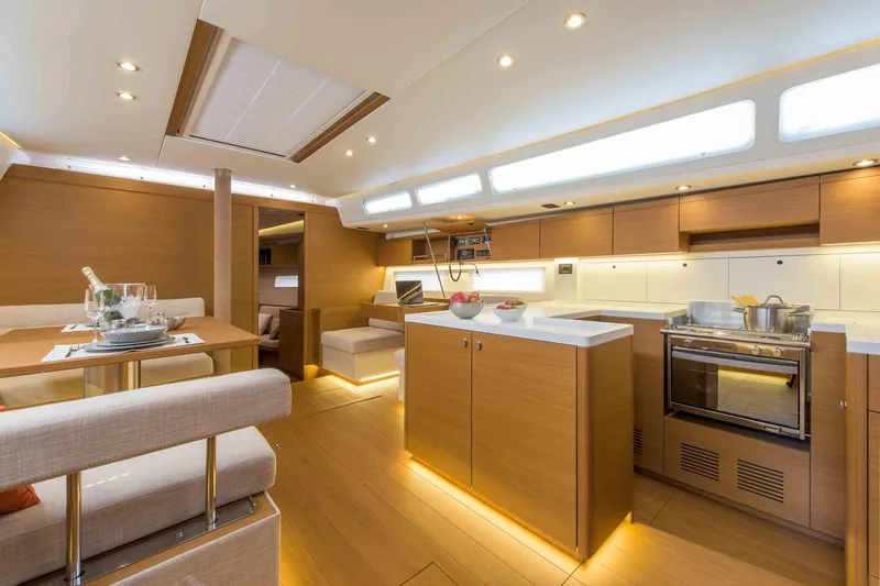  Yacht Photos Pics Luxurious interior of 2025 Grand Soleil 52 LC yacht with modern kitchen and dining area.