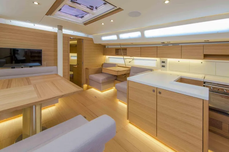  Yacht Photos Pics Luxurious interior of 2025 Grand Soleil 52 LC yacht with modern wood finish and ambient lighting.