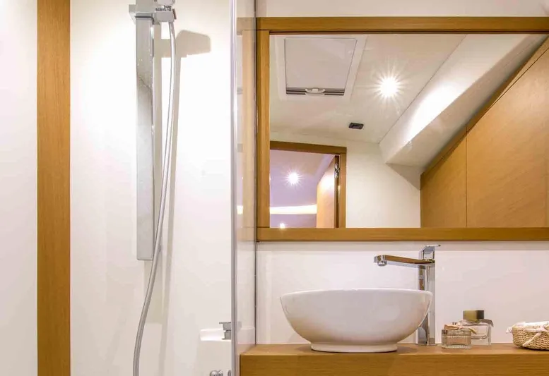  Yacht Photos Pics Modern bathroom interior on 2025 Grand Soleil 52 LC yacht, featuring sleek fixtures and wooden accents.