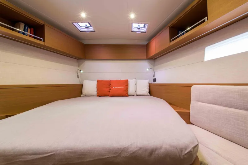  Yacht Photos Pics Luxurious cabin interior of 2025 Grand Soleil 52 LC yacht with cozy bed and modern lighting.
