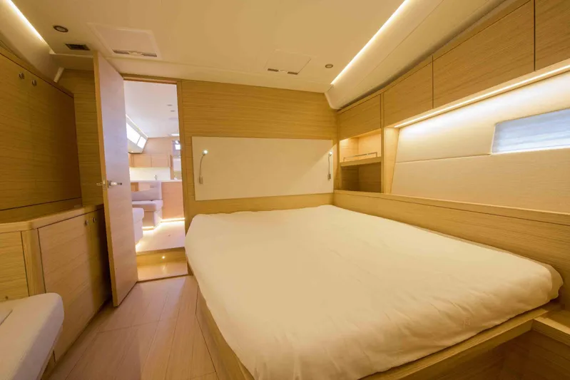  Yacht Photos Pics Luxurious interior of 2025 Grand Soleil 52 LC yacht, featuring a spacious bedroom with modern design.