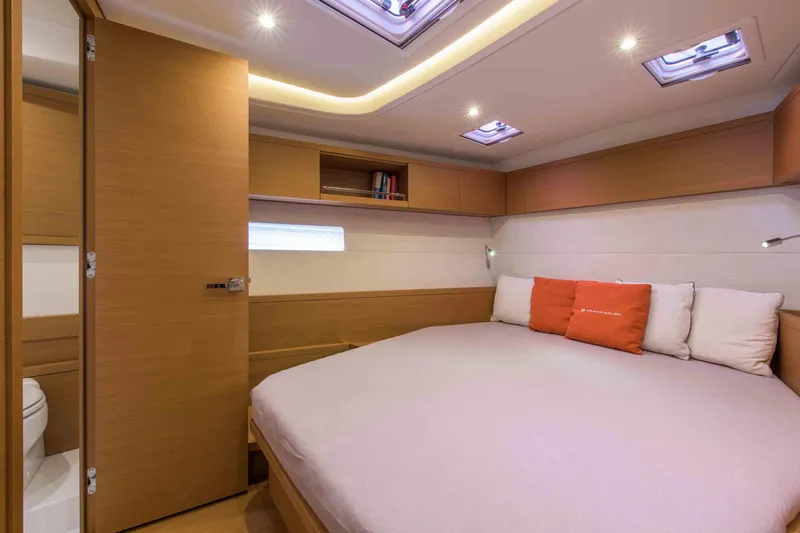  Yacht Photos Pics Luxurious cabin interior of 2025 Grand Soleil 52 LC yacht with cozy bed and modern lighting.