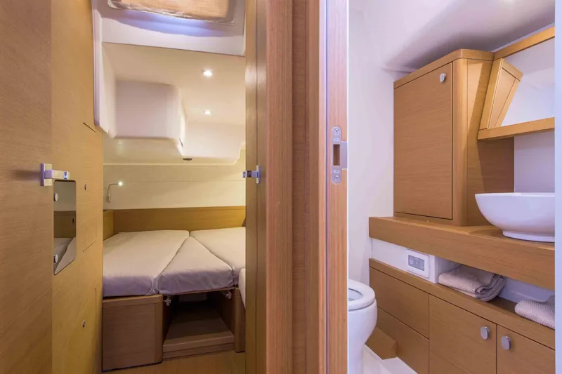  Yacht Photos Pics Luxurious interior of 2025 Grand Soleil 52 LC yacht featuring bedroom and bathroom.