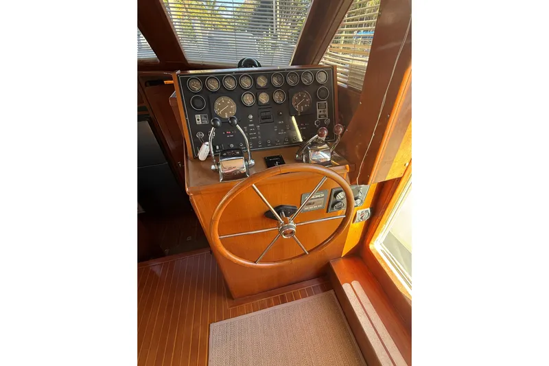 Southern Flite Yacht Photos Pics 1990 Offshore Yachts 48 Yachtfisher helm with wooden wheel and instrument panel.