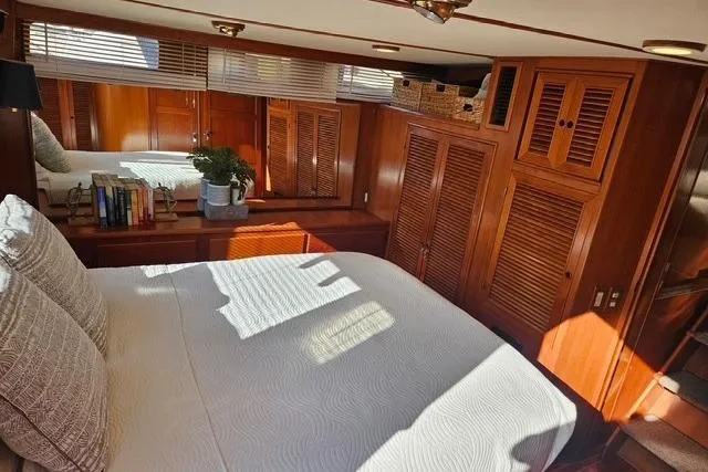 Southern Flite Yacht Photos Pics Cozy 1990 Offshore Yachts Trawler bedroom with wooden interior and natural light.