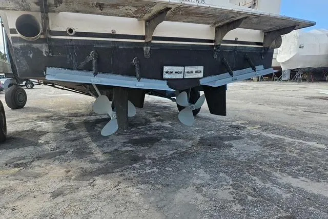 Southern Flite Yacht Photos Pics 1990 Offshore Yachts Trawler on dry dock, showcasing propellers and hull details.