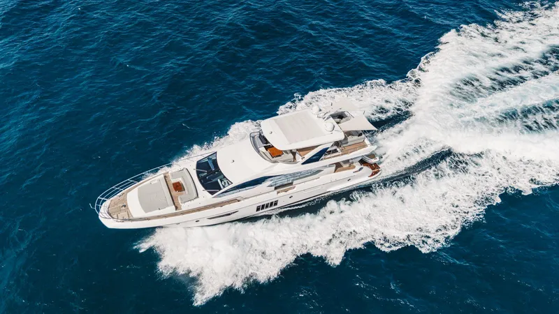 April Fools Yacht Photos Pics Azimut 80 Flybridge 2018 yacht cruising on open blue sea, aerial view.