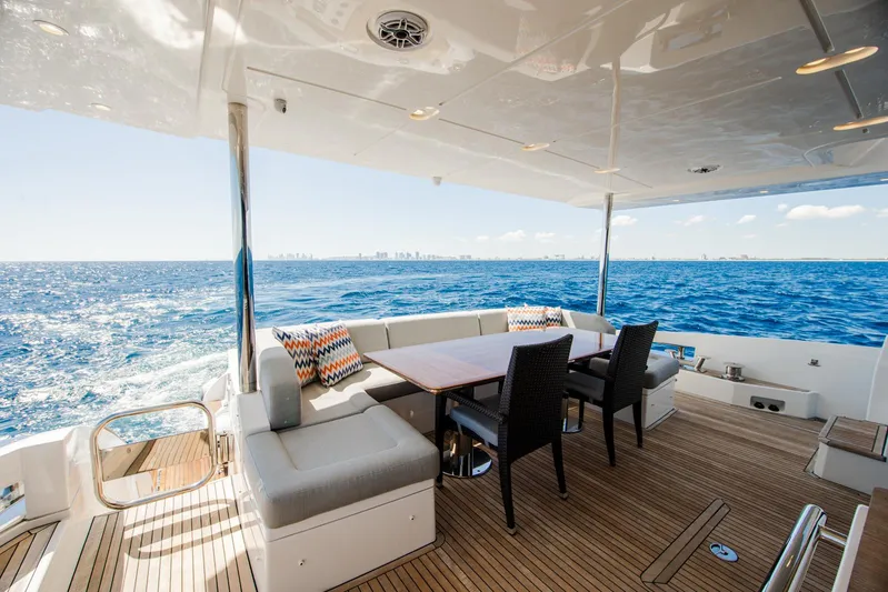 April Fools Yacht Photos Pics Luxurious 2018 Azimut 80 Flybridge yacht with elegant outdoor seating and ocean view.