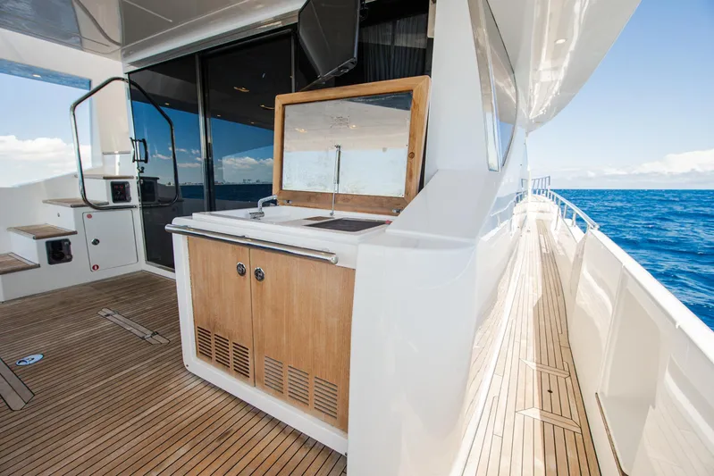 April Fools Yacht Photos Pics Azimut 80 Flybridge 2018 yacht deck with wooden flooring and ocean view.