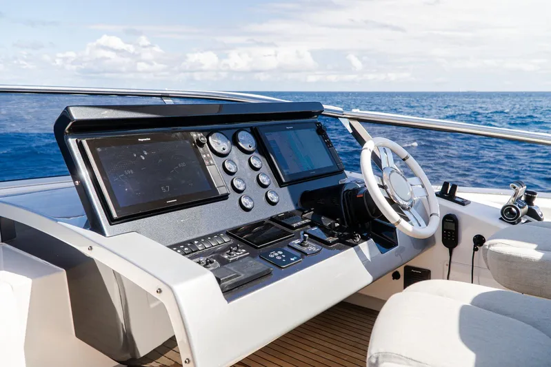 April Fools Yacht Photos Pics Cockpit of 2018 Azimut 80 Flybridge yacht with ocean view and modern controls.