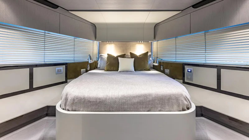 April Fools Yacht Photos Pics Luxurious bedroom interior of 2018 Azimut 80 Flybridge yacht with modern design and ambient lighting.