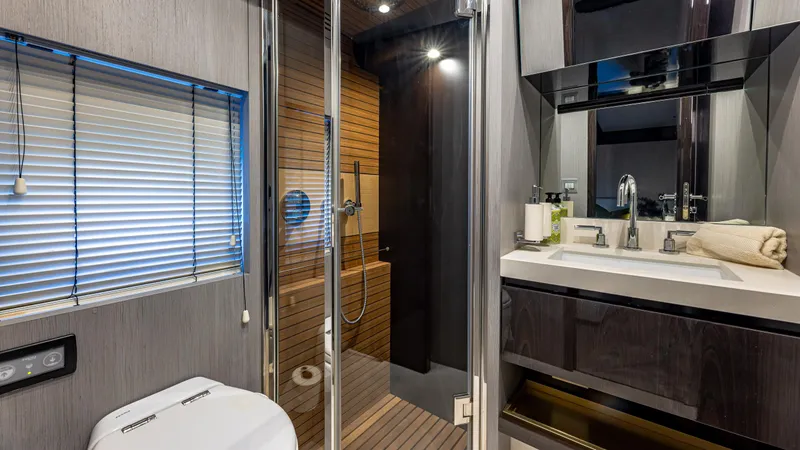 April Fools Yacht Photos Pics Luxurious bathroom interior of 2018 Azimut 80 Flybridge yacht with modern fixtures and wooden accents.