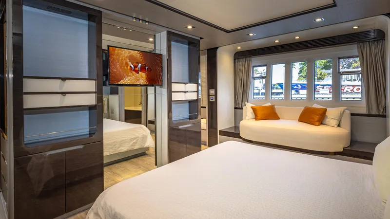 April Fools Yacht Photos Pics Luxurious bedroom interior of 2018 Azimut 80 Flybridge yacht with modern decor and large windows.