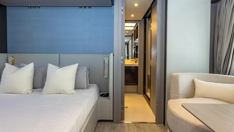 April Fools Yacht Photos Pics Luxurious interior of 2018 Azimut 80 Flybridge yacht featuring a cozy bedroom and modern bathroom.