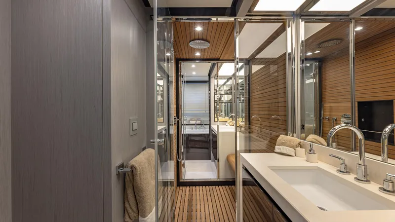 April Fools Yacht Photos Pics Luxurious bathroom interior of 2018 Azimut 80 Flybridge yacht with modern fixtures and wood accents.
