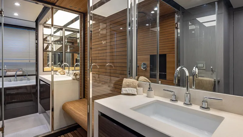 April Fools Yacht Photos Pics Luxurious bathroom interior on 2018 Azimut 80 Flybridge yacht with modern fixtures and wood accents.