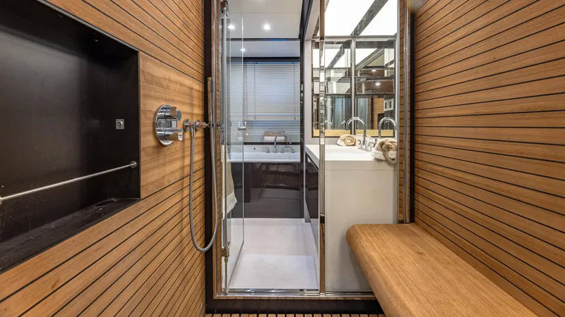 April Fools Yacht Photos Pics Luxurious bathroom in 2018 Azimut 80 Flybridge yacht with wood paneling and modern fixtures.